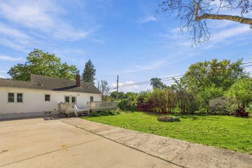Expansive Backyard with Large Concrete Area for Outdoor Games & Gatherings