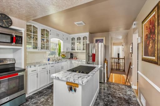 The kitchen window & white cabinetry keep this space bright