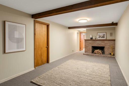 watermarked_img_6511657983971816793 6432 Lower level family room. Seller does not know if the fireplace works.jpg