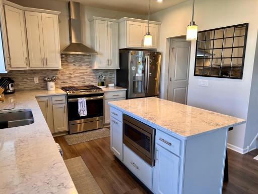 Sun-filled kitchen, microwave built into kitchen island and beautiful engineered hardwood floors.jpeg