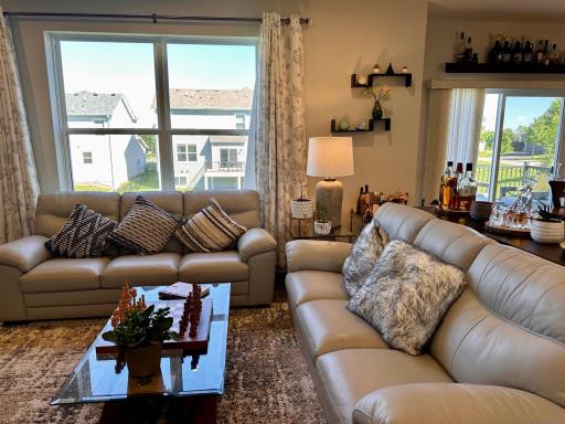 Large windows and sliding glass door lets the sun fill this open concept floorplan.jpeg