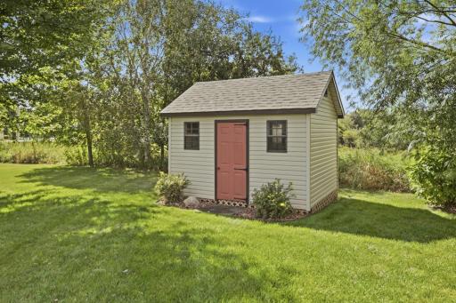 The accessory shed also offers a separate service door and two windows let in natural light.