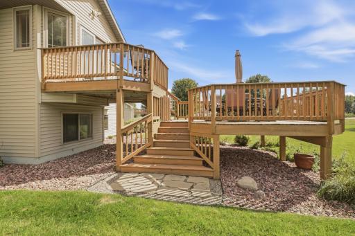 Wide entry steps to two tier deck with large paver stones and gravel to keep down the weeds.