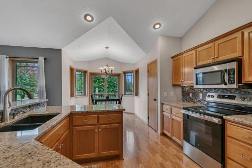 Custom cabinetry with concealed hinges, a built-in pullout cutting board, and a convenient pantry just steps away.