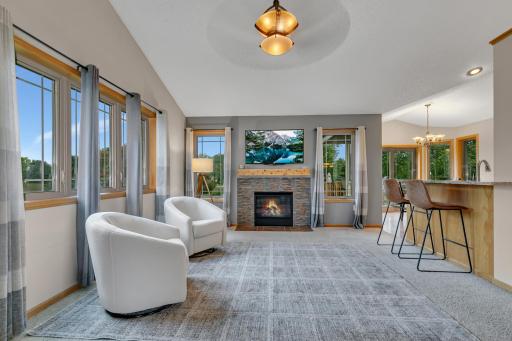 The living room features a gas fireplace with a tiled surround and wood mantle, creating a natural gathering space.