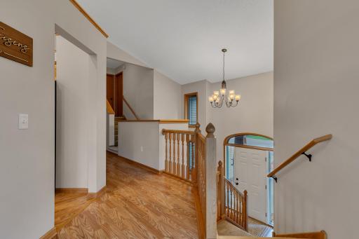 Hallway above foyer. The foyer features a double bifold closet and showcases a transom window and sidelights, allowing natural light in while giving you a clear view of the front door.
