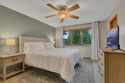 The primary suite provides a comfortable retreat with a ceiling fan, walk-in closet, and private 3/4 bathroom.