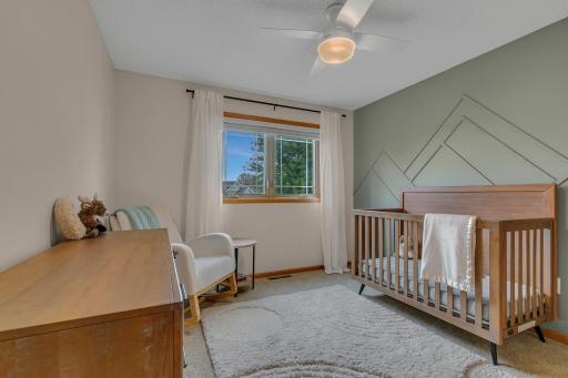 Here is the first of the two bedrooms that are located above the garage, each with a ceiling fan.
