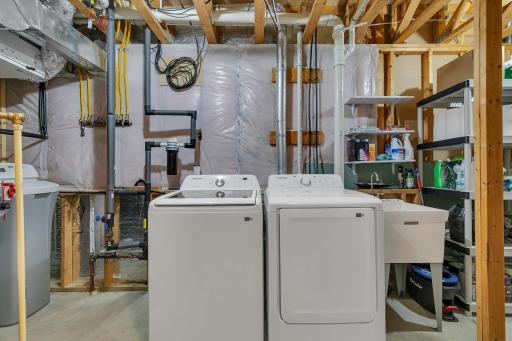 The Samsung washer and dryer (new Dec 2025) may remain with the home, along with the adjacent utility sink.