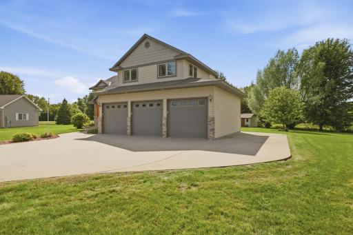 There is a large concrete parking pad alongside the garage that offers additional parking.