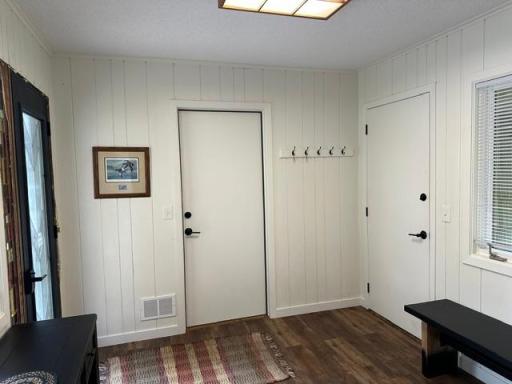 Doors that lead to the attached garage and back yard