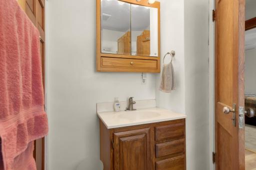 Upper-level full bathroom with updated flooring and wood vanity