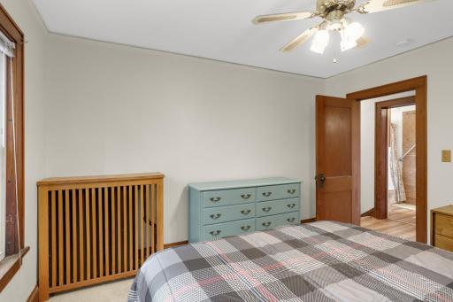 Comfortable upper-level bedroom with new carpet, original woodwork, and closet storage
