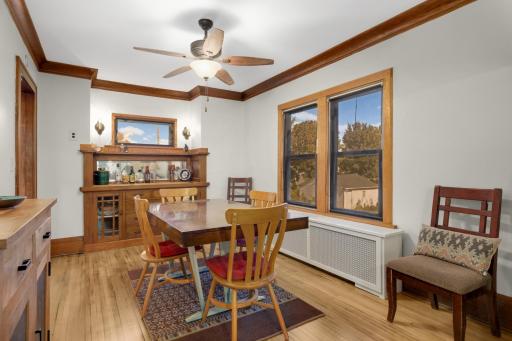 Formal dining room with original woodwork, built-in cabinetry, and large windows