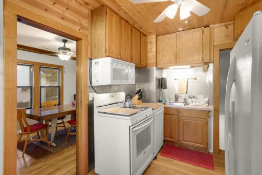 Functional kitchen with abundant wood cabinetry and convenient access to the dining room