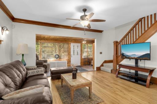 Spacious living room with refinished hardwood floors and original woodwork