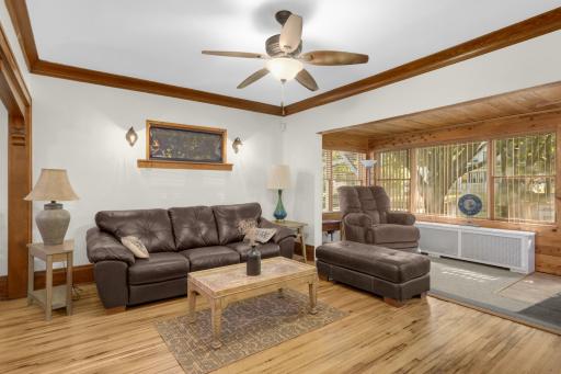 Bright living room featuring crown molding and abundant natural light