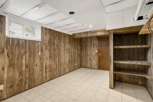 Another view of the lower-level flex space with built-in shelving