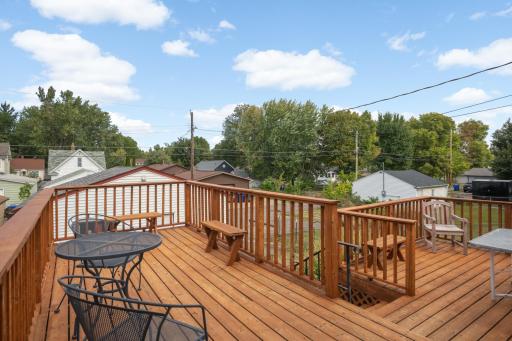 Elevated deck overlooks the fenced backyard and garage