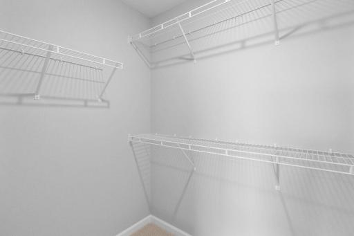 A big walk-in closet with plenty of shelving to go around.