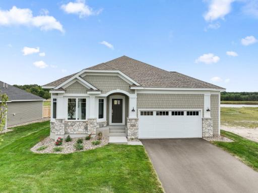Pulling up to the home you see a breath taking three windows along with beautiful architecture and landscape.
