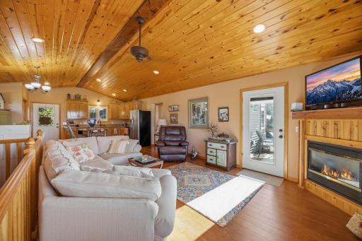 A nice view of the living room and kitchen area and also the deck outside the door.