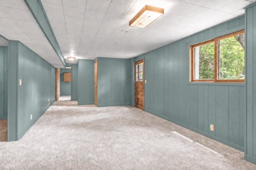 Lower level features 2 large family rooms, private 4th bedroom, additional bathroom and walkout entrance/exit to the big back yard. This photo has been digitally enhanced.