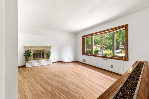 Living room also features a fun half wall with garden box to decorate seasonally with fresh or fake plants and flowers.