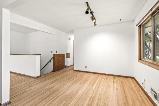 Stairs to the lower level are to the left of the dining space and close off easily with a half door (against the wall to the right of the stair railing) for extra charm.