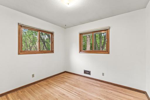 And bedroom #3, another corner location with elevated window views of the backyard.