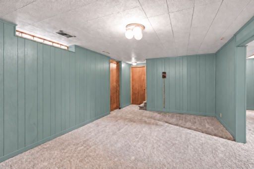 Door straight ahead leads to the laundry and utility room. There is a lot of storage space and a workbench.
