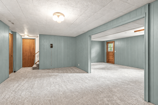 Lower level family rooms with walkout! The walls were recently painted BEHR 'In the Moment' T18-15 (color simulator is not a perfect match). Go see it in person! Photo is digitally enhanced.