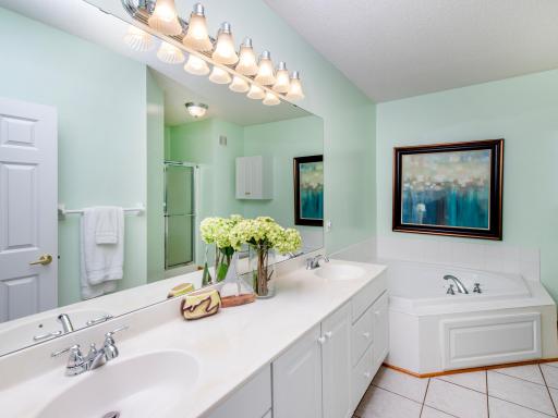 Spacious ensuite with a double-sink vanity, soaking tub and walk-in shower.