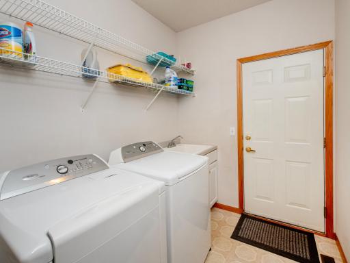 Laundry/mudroom with a utility sink and shelving for extra storage space.
