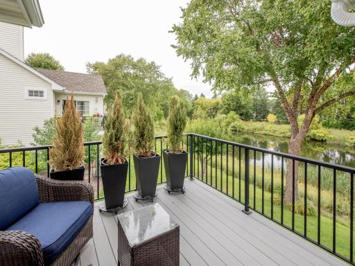 Step onto the deck and enjoy peaceful pond views in a serene outdoor setting.