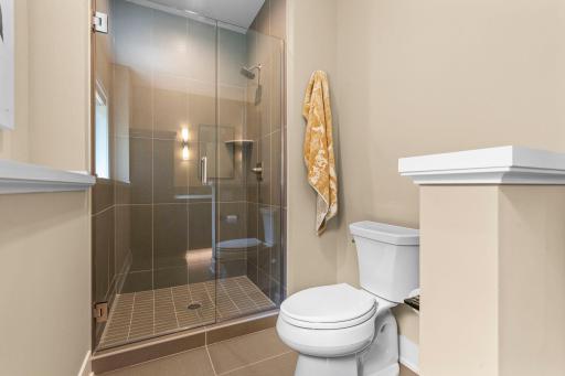Walk-in shower featuring a beautiful tile surround.