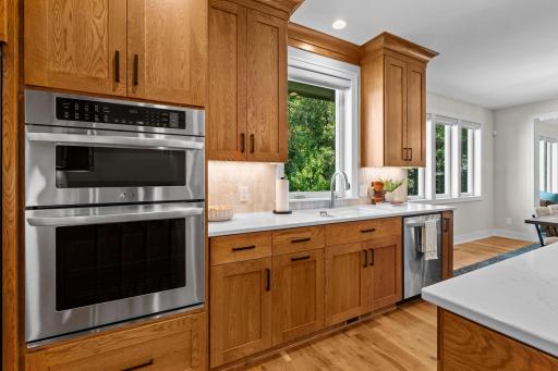 Stainless steel appliances complement the natural light streaming through the side-yard window above the sink.