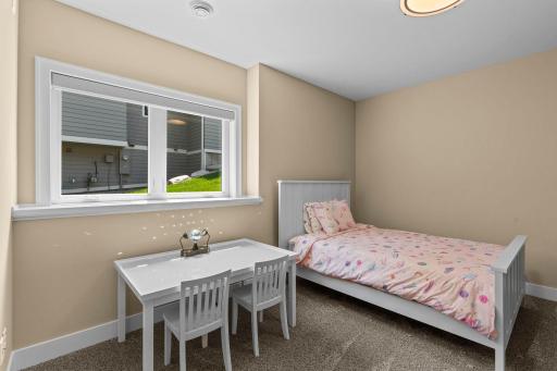 Bedroom 2 on the lower level offering a spacious walk-in closet and look out views.