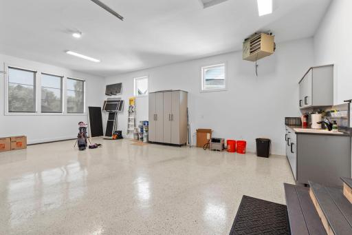Fully finished and heated garage featuring durable epoxy flooring.
