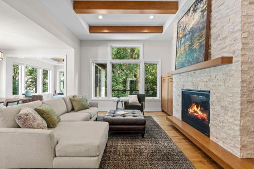 Large picture windows overlook the backyard, filling the space with natural light.