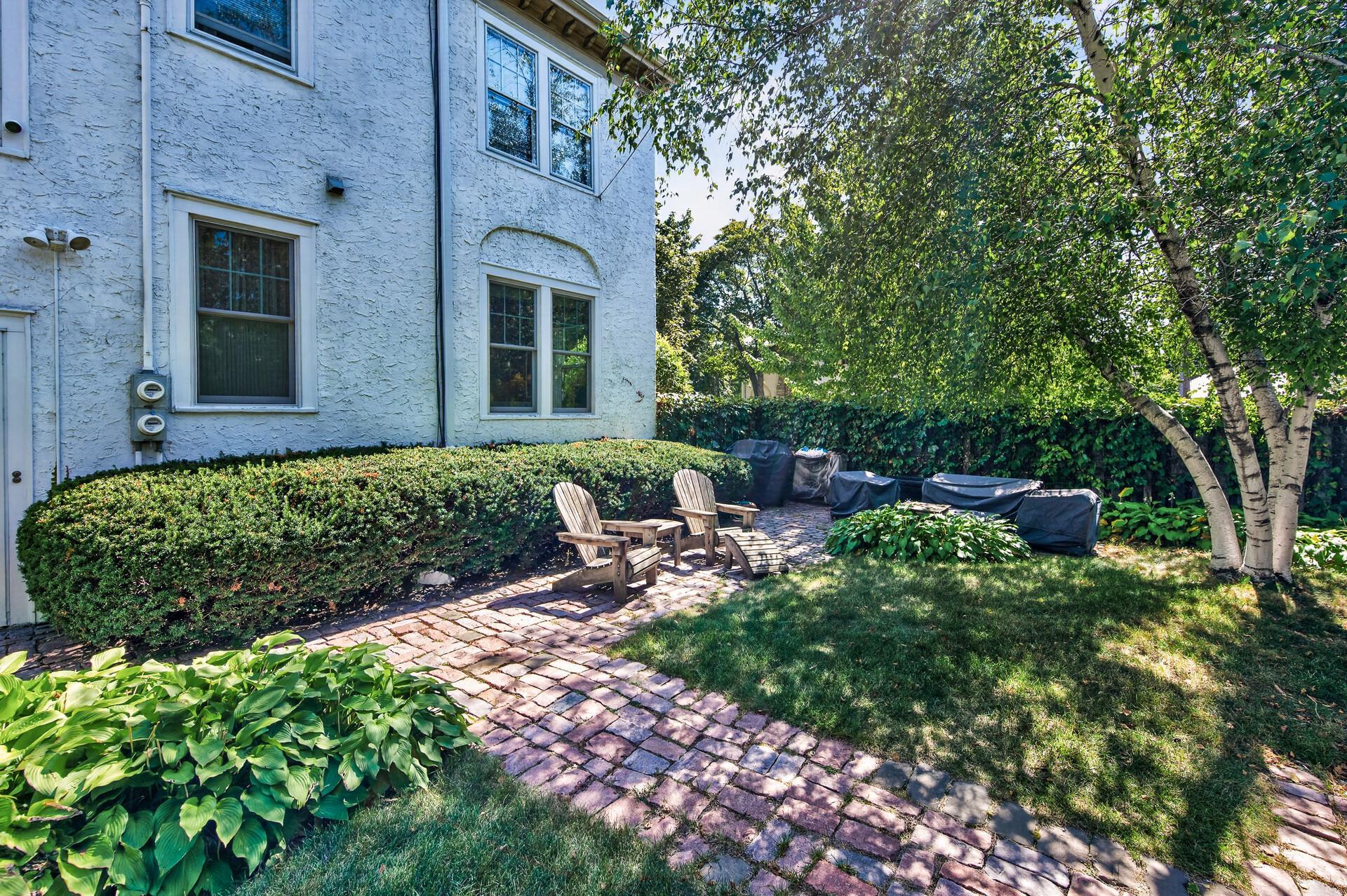 A little brick patio tucked among the greenery.