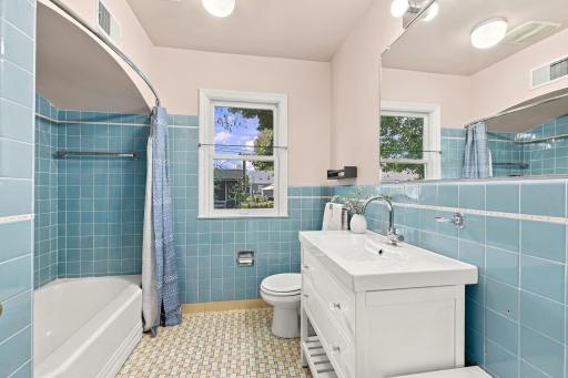 Main floor full bathroom with original tile work in pristine condition.