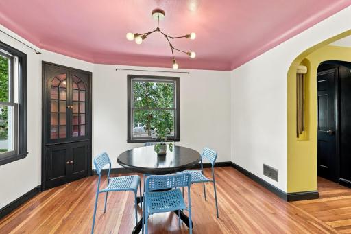 Formal dining space with original built-in's, newer windows and custom light fixture.