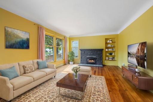 Bright and sunny living room with huge windows that make you feel like you are living in nature, built-in bookshelves, wood-burning fireplace and lovely tile work--- curl up with your favorite book in your happy place!
Virtually staged photo.