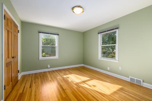 Main floor bedroom with big closet and oak wood flooring.