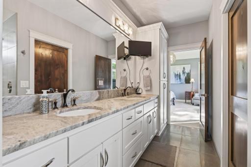 The primary bath has two sinks and granite counter space.