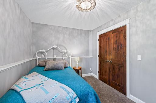 The bedroom has a large closet with double hanger bars.