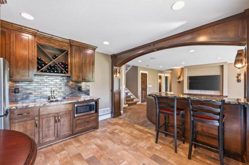 The wet bar behind the family room makes popcorn and beverages convenient.