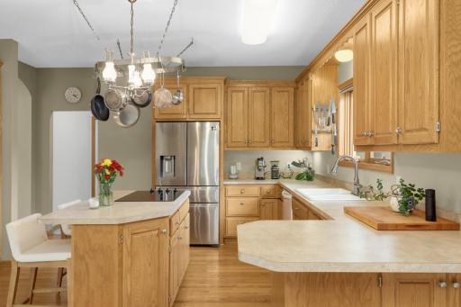 Designed with plenty of room to cook and gather, the Kitchen features extensive cabinetry, generous counter space, a center island and stainless-steel refrigerator. The refrigerator and double wall ovens were replaced in 2022 and the cooktop in 2024.
