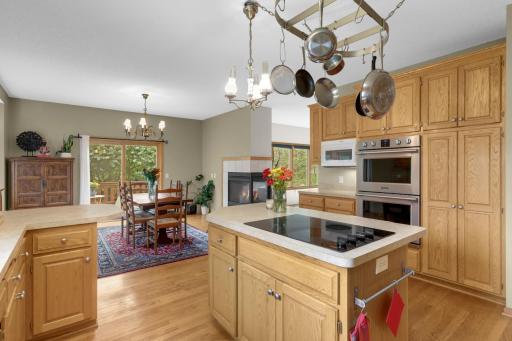 Great layout for entertaining and cooking with a center cooktop island, wall ovens and plenty of cabinetry and workspace!